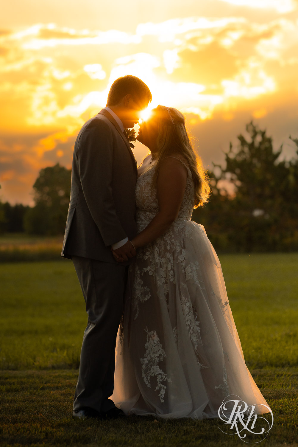 Bride and groom looking at each other at sunset