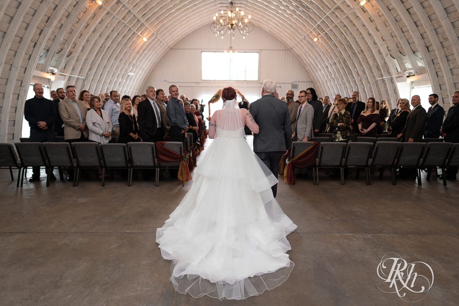 Bride walking down the aisle with her dad at The Mill Events in Chetek, Wisconsin.