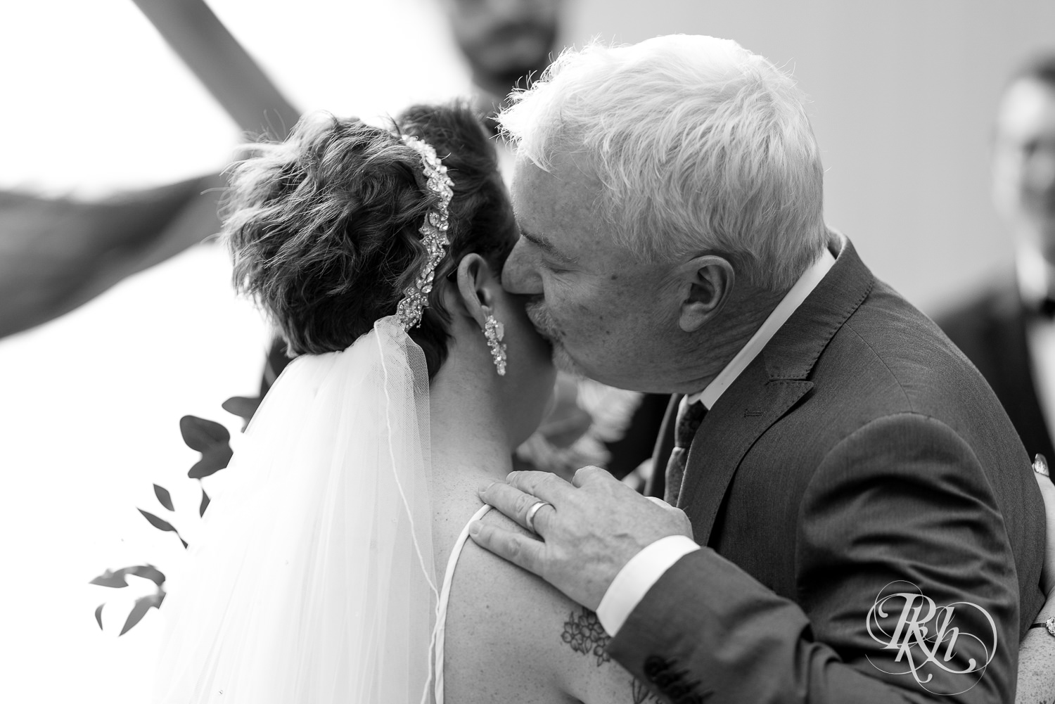 Dad kissing bride at The Mill Events in Chetek, Wisconsin.