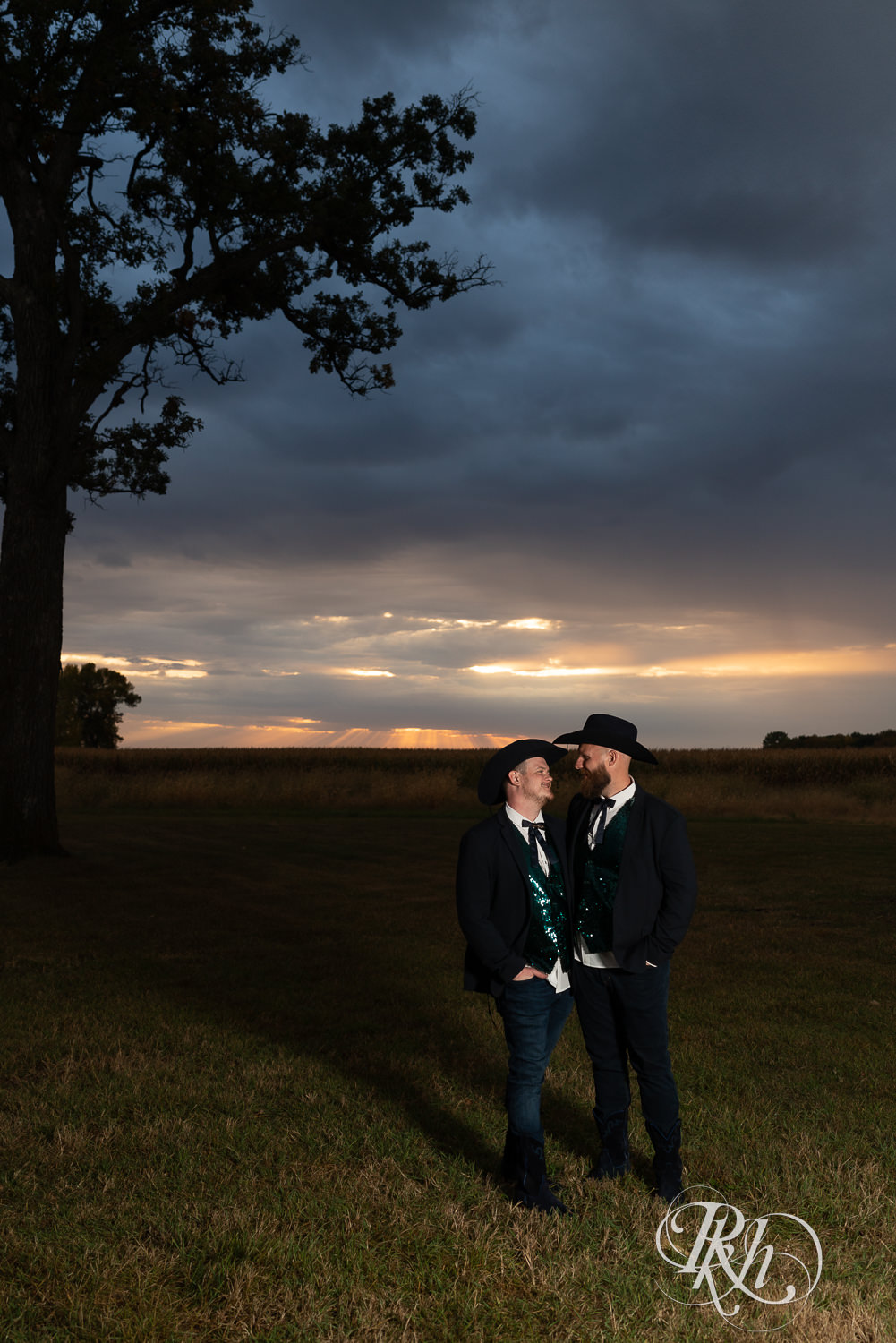 Grooms looking at each other during sunset on their wedding day.