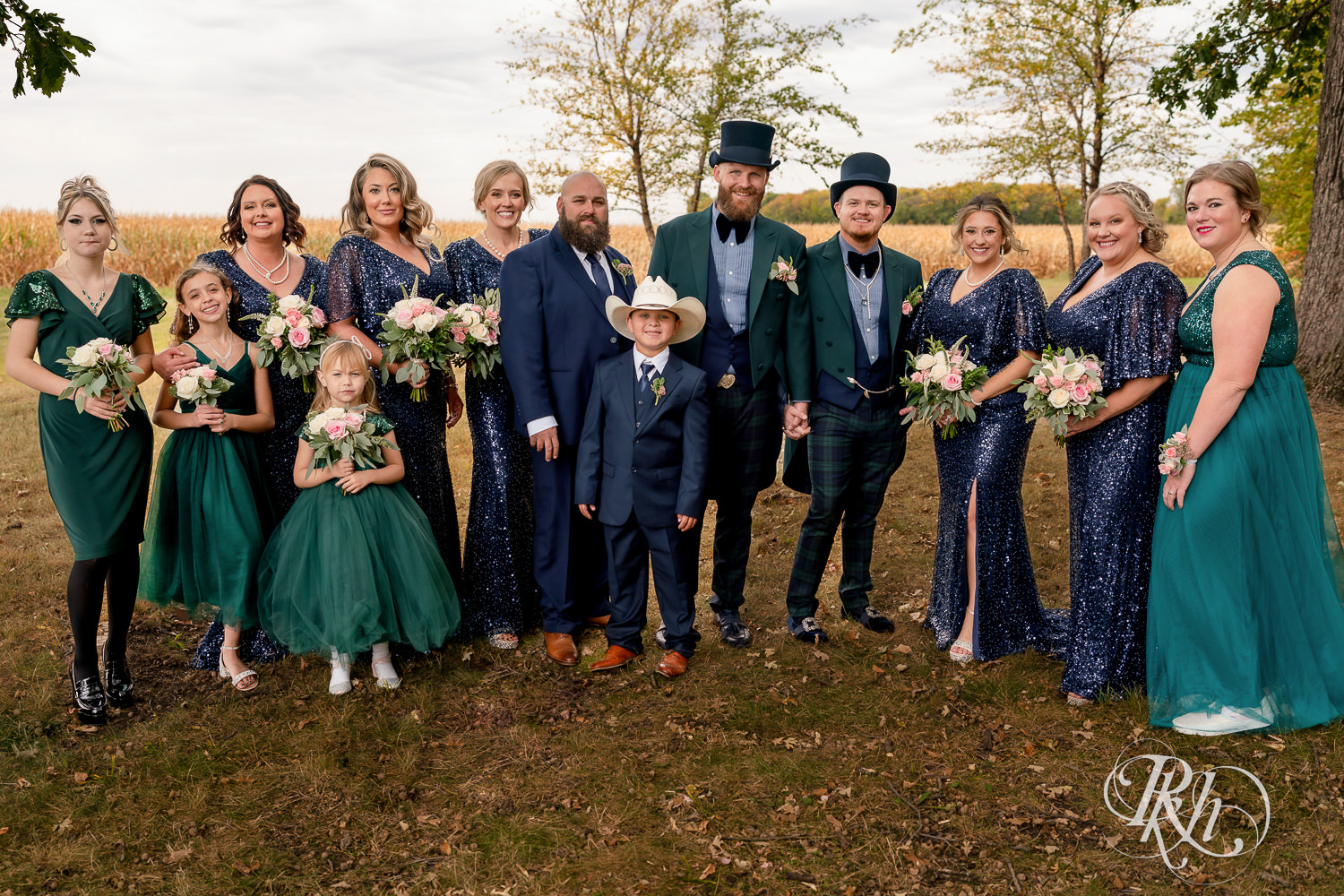 Gay wedding party with grooms wearing tophats and bridesmaids wearing sequin dresses.