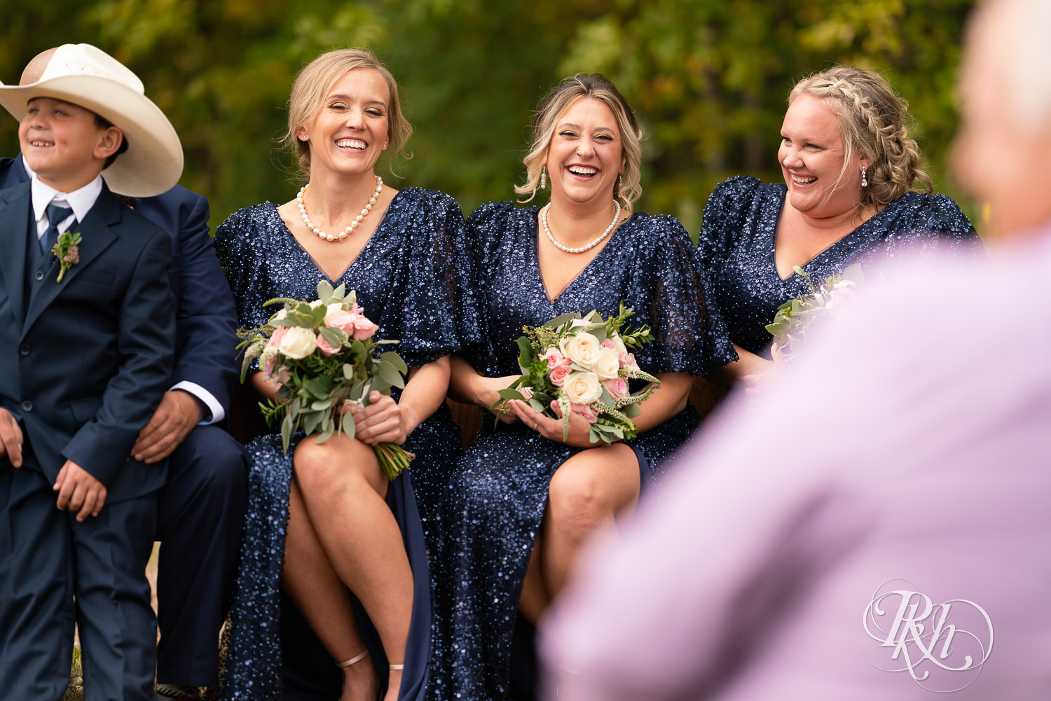 Bridesmaids laughing candidly at wedding in Belle Plaine, Minnesota.