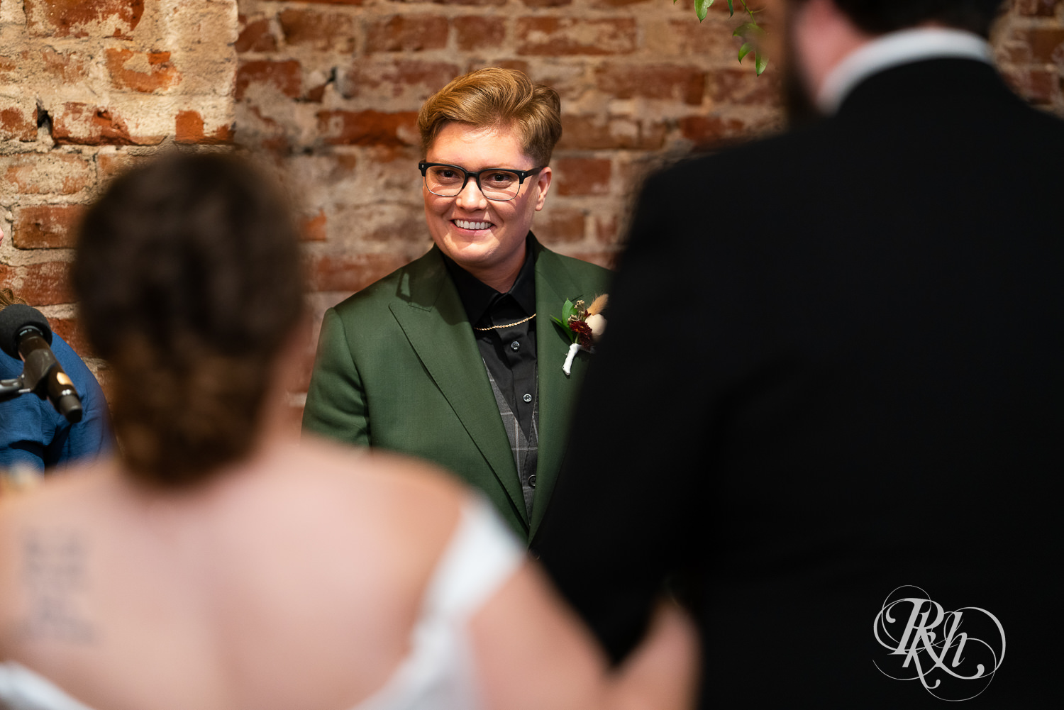 Lesbian bride seeing her bride walking down to aisle at Earl Wilson Event Center in Saint Paul, Minnesota.