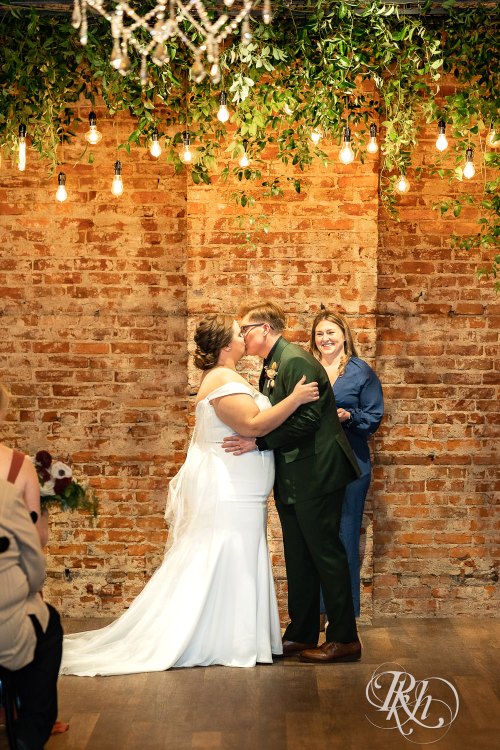 lesbian wedding first kiss under lights