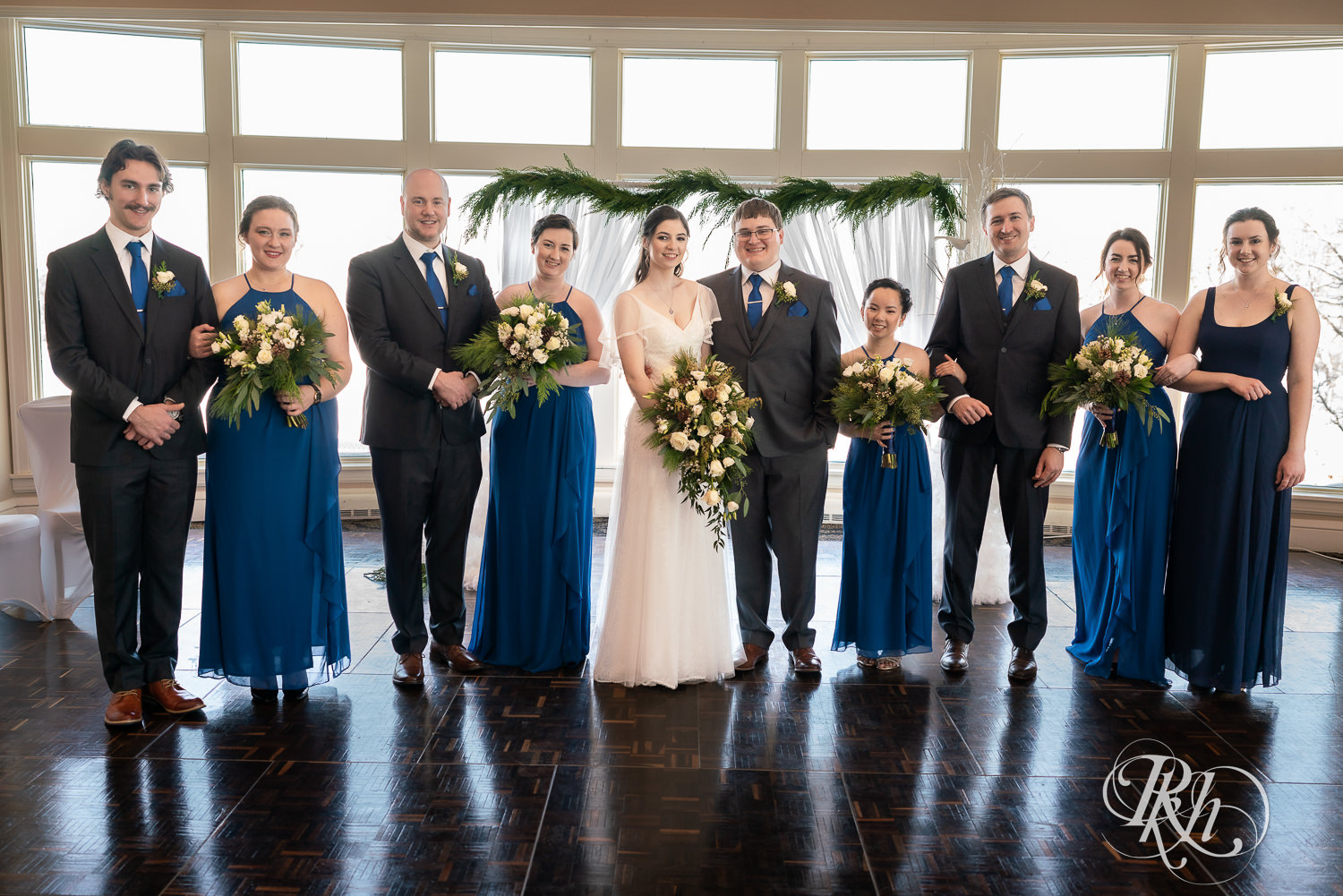 Wedding party in blue dresses and grey suits at Minneapolis Golf Club in Saint Louis Park, Minnesota.