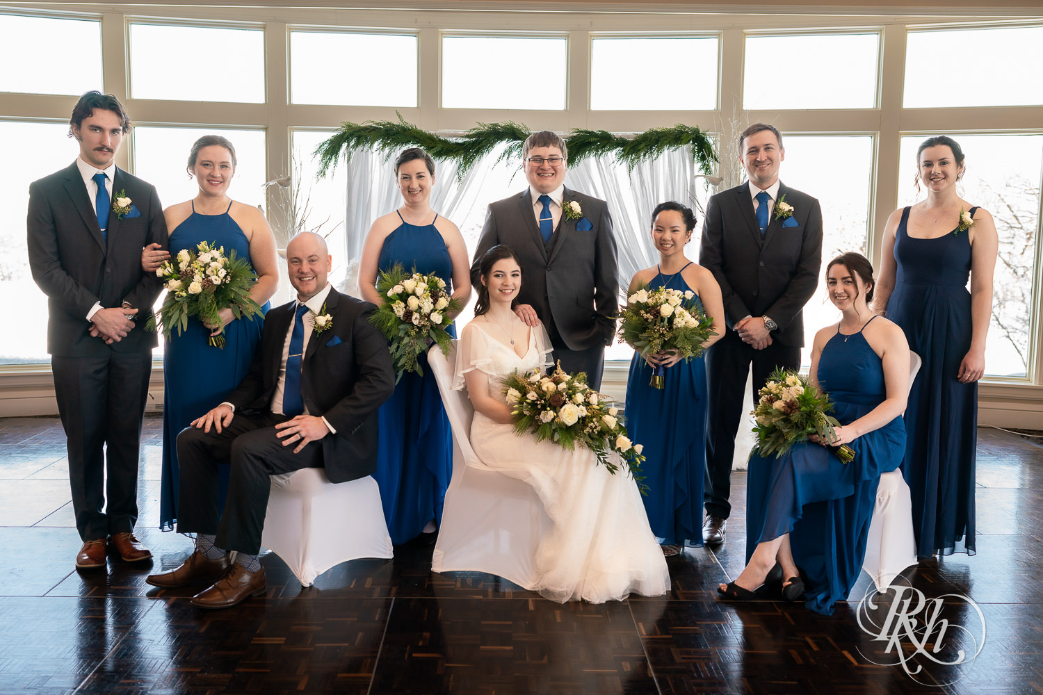 Wedding party in blue dresses and grey suits at Minneapolis Golf Club in Saint Louis Park, Minnesota.
