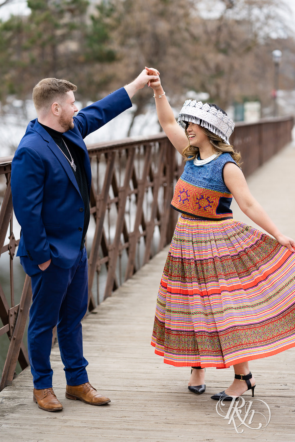 Man and Hmong woman dance on bridge in Saint Anthony Main in Minneapolis, Minnesota.