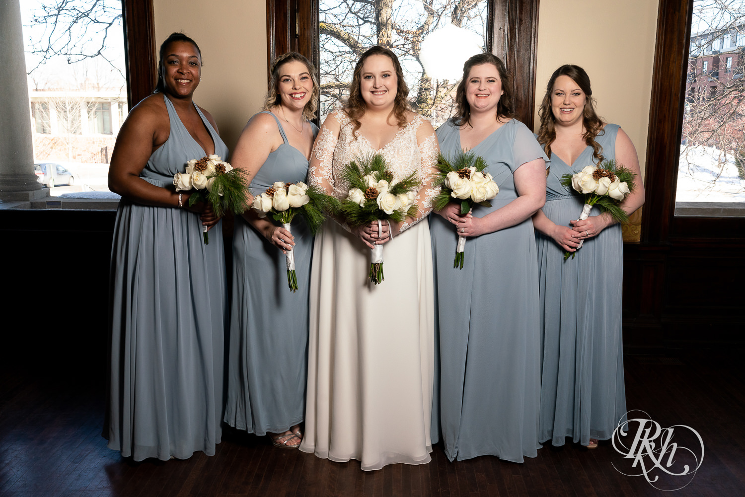 Wedding party in blue dresses smiling at Semple Mansion in Minneapolis, Minnesota.