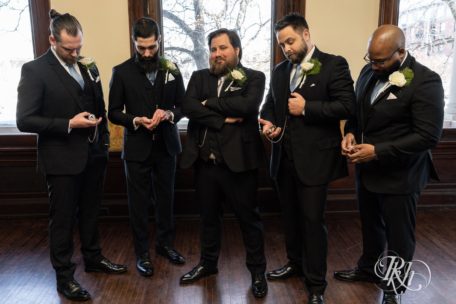 Wedding party in black suits smiling at Semple Mansion in Minneapolis, Minnesota.