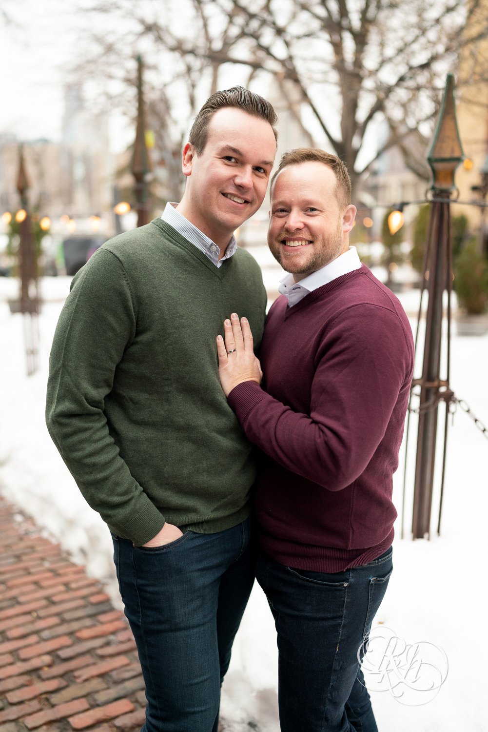 Gay men smile in snow during the winter in Minneapolis, Minnesota.