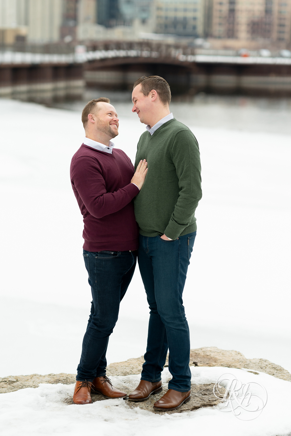 Gay men smile in snow during the winter in Minneapolis, Minnesota.