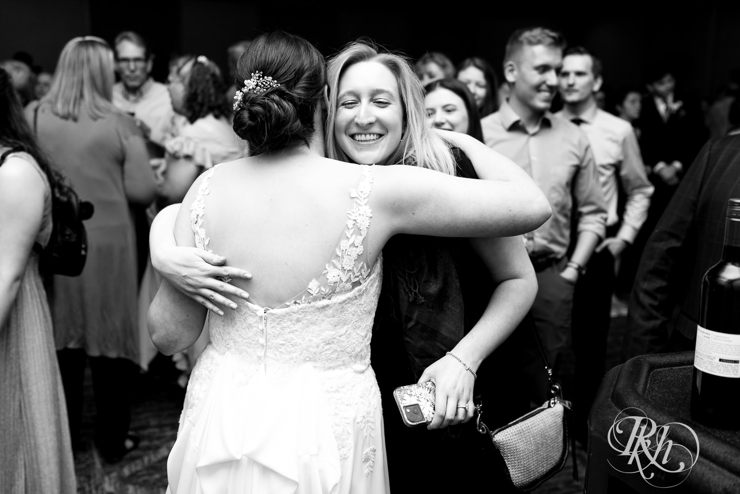 Guest hugs bride at wedding reception at Doubletree Hilton Saint Paul in Saint Paul, Minnesota.