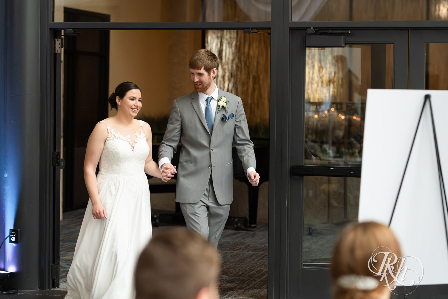 Bride and groom enter wedding reception at Doubletree Hilton Saint Paul in Saint Paul, Minnesota.