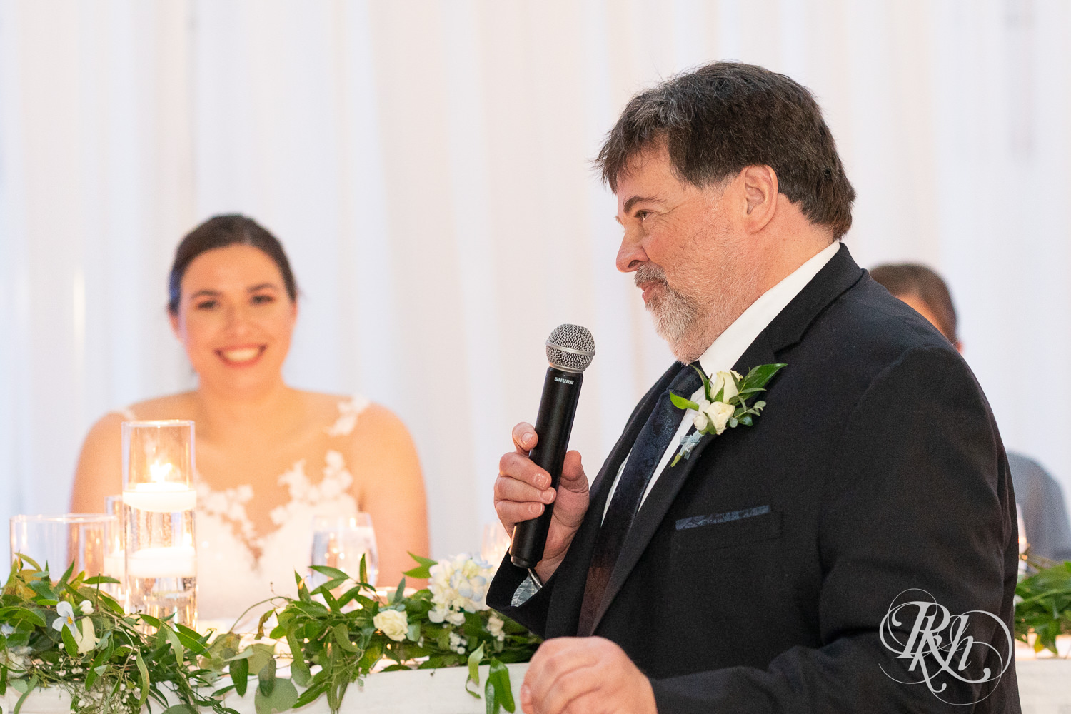 Dad smiles during wedding speeches at Doubletree Hilton Saint Paul in Saint Paul, Minnesota.