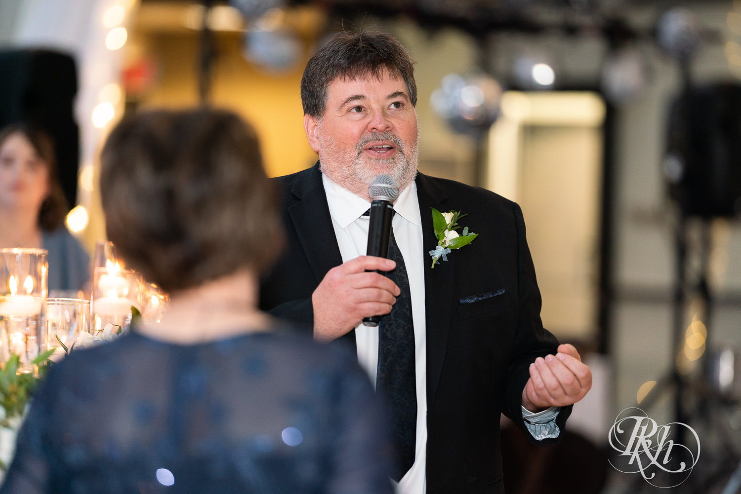 Dad smiles during wedding speeches at Doubletree Hilton Saint Paul in Saint Paul, Minnesota.