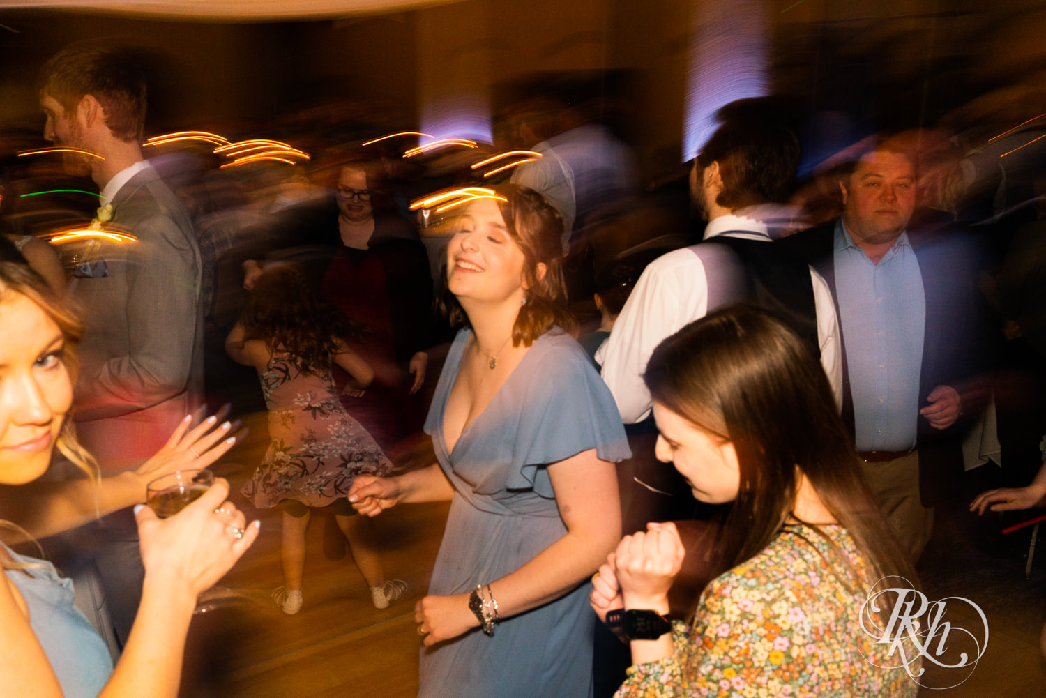 Bride and groom dance with guests at wedding reception at Doubletree Hilton Saint Paul in Saint Paul, Minnesota.