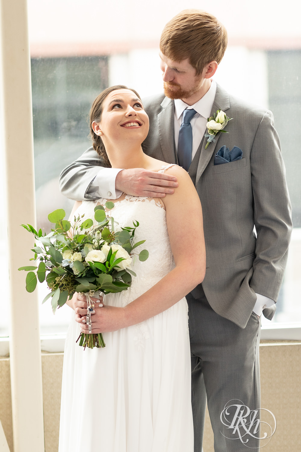 Bride and groom smile at Doubletree Hilton Saint Paul in Saint Paul, Minnesota.