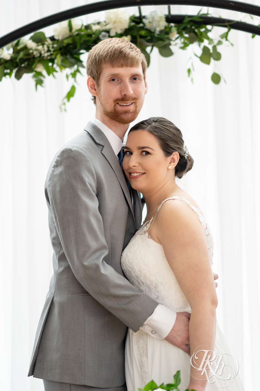 Bride and groom smile on alter at Doubletree Hilton Saint Paul in Saint Paul, Minnesota.