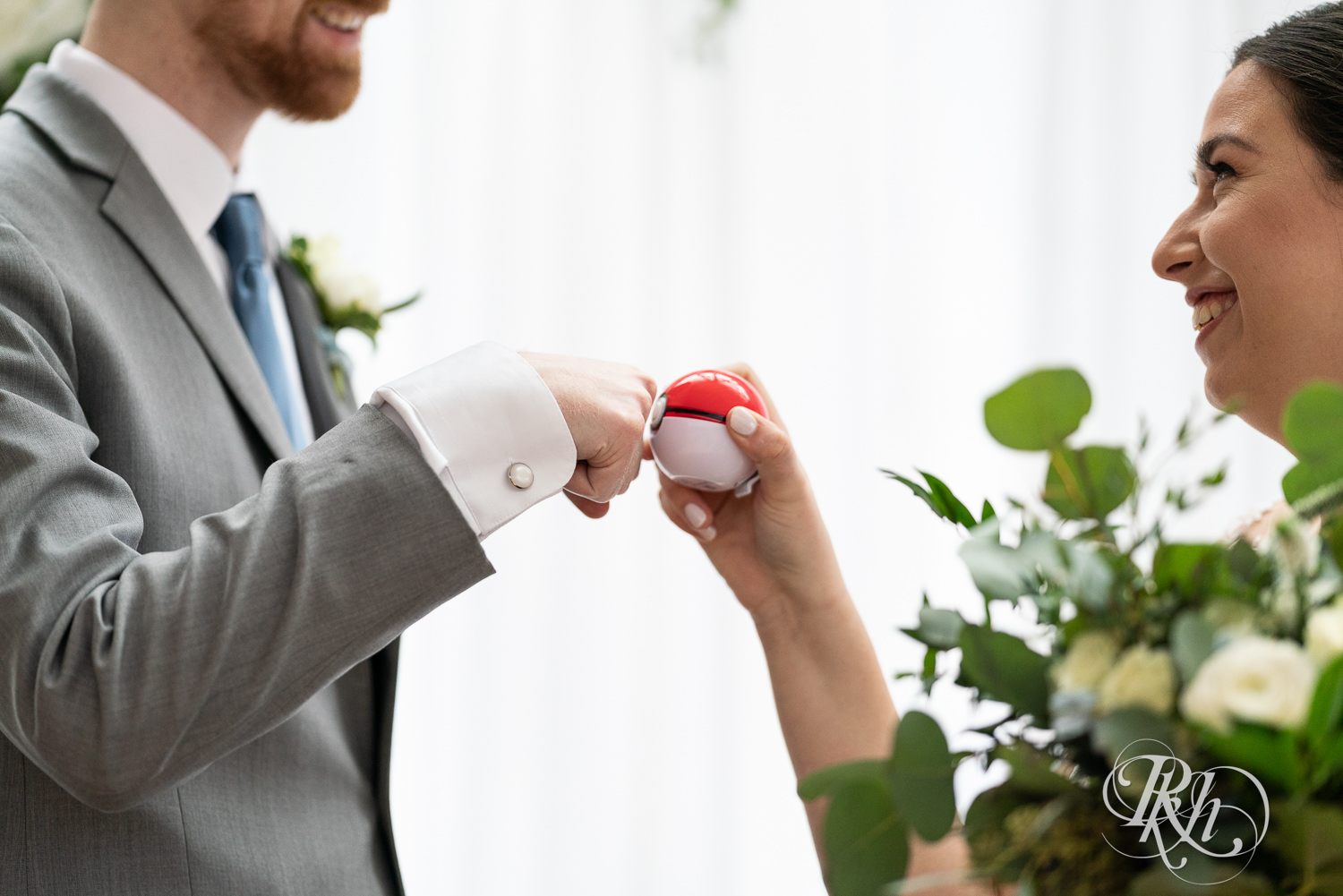 Bride and groom playing with Pokemon ball and laughing on alter at Doubletree Hilton Saint Paul in Saint Paul, Minnesota.