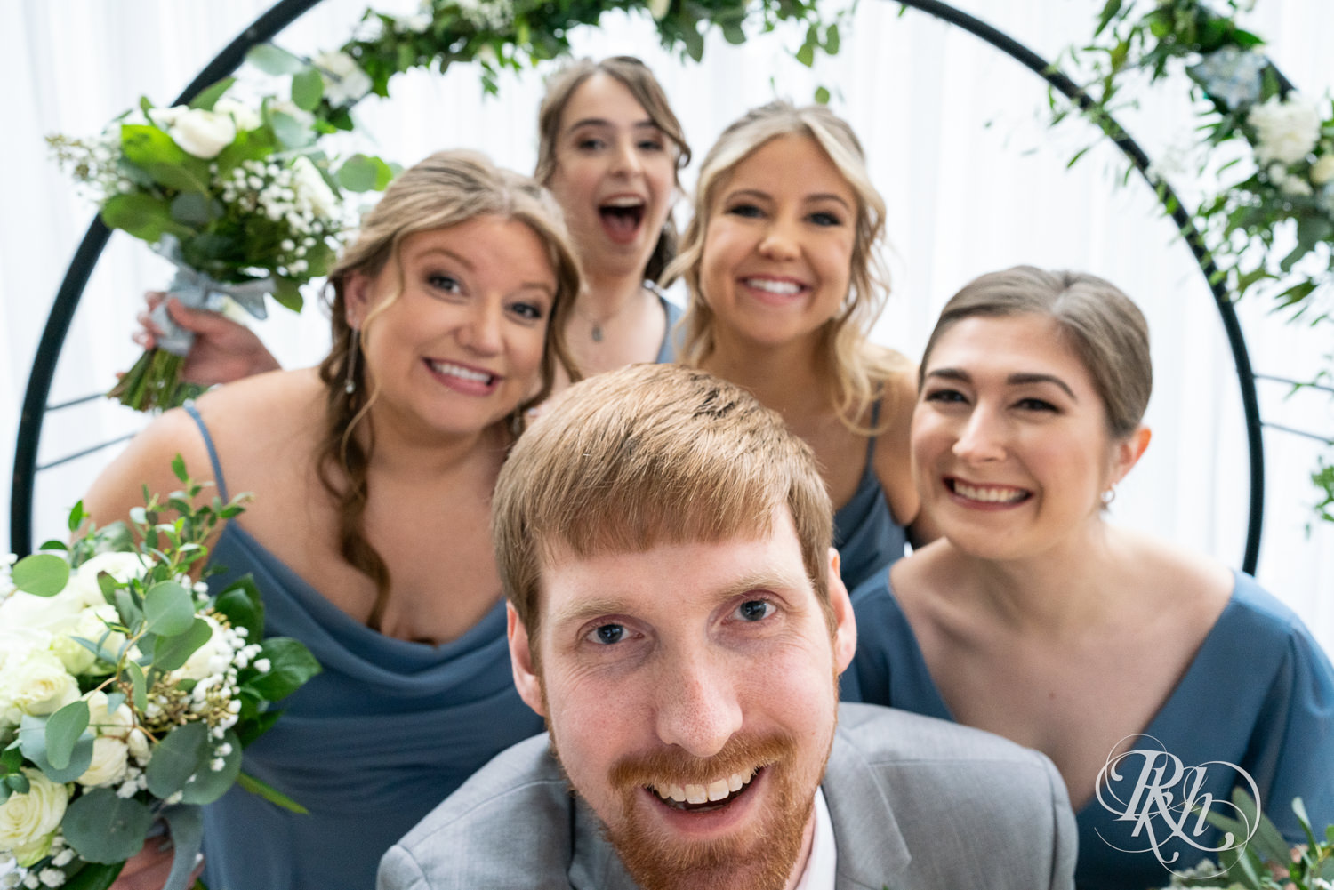 Wedding party smiles together at Doubletree Hilton Saint Paul in Saint Paul, Minnesota.