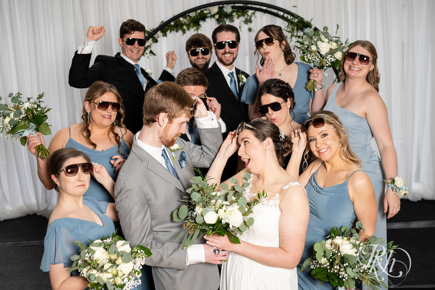 Wedding party wear sunglasses together at Doubletree Hilton Saint Paul in Saint Paul, Minnesota.