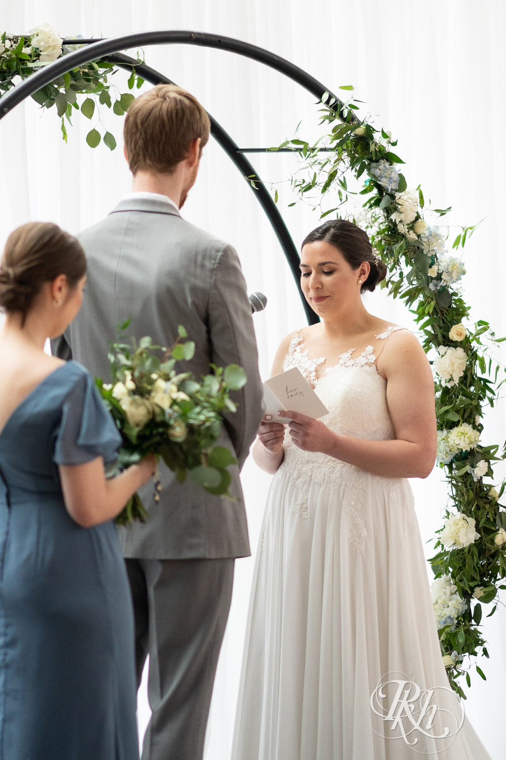 Bride reads vows during wedding ceremony at Doubletree Hilton Saint Paul in Saint Paul, Minnesota.