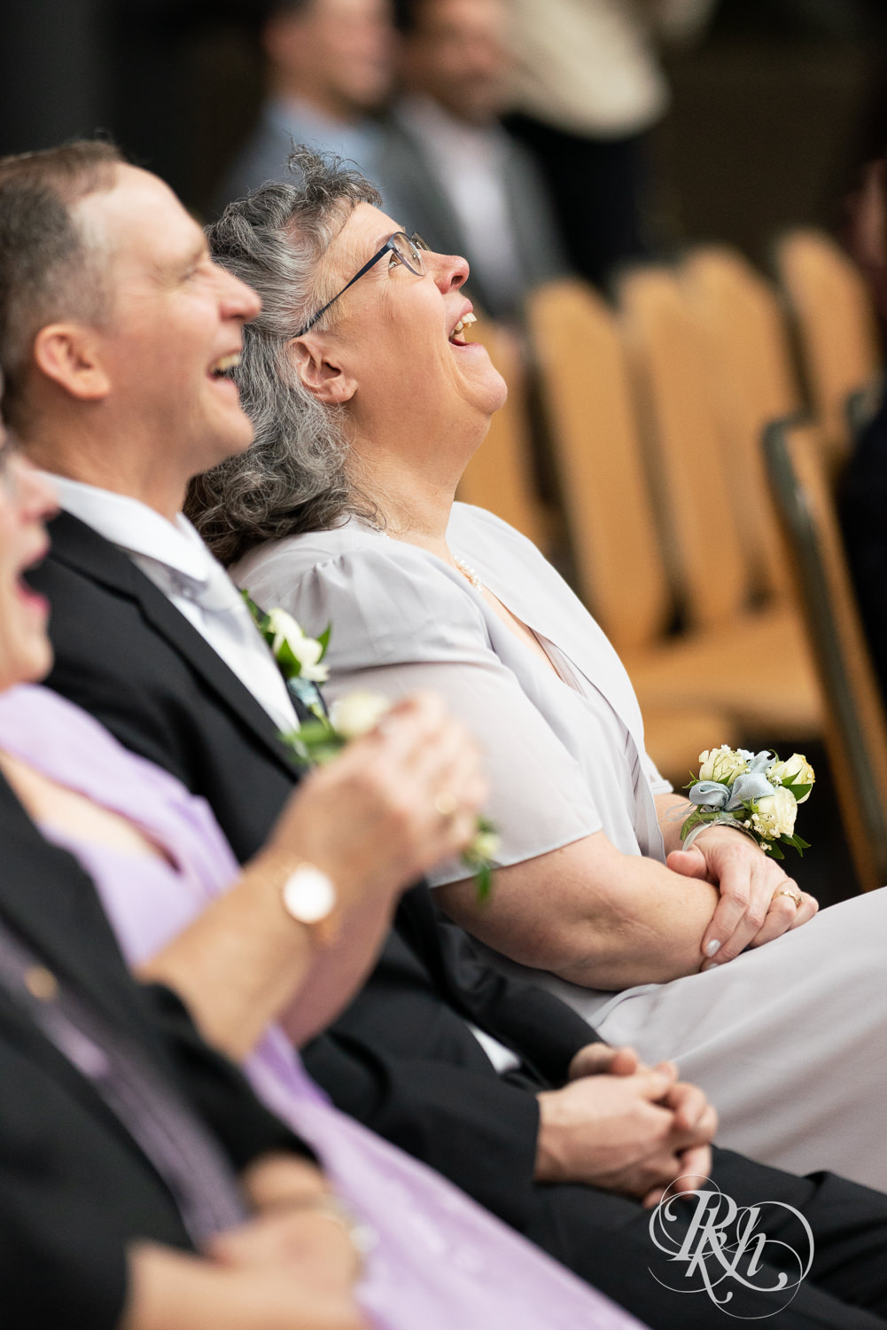 Groom's mom laughs during wedding ceremony at Doubletree Hilton Saint Paul in Saint Paul, Minnesota.