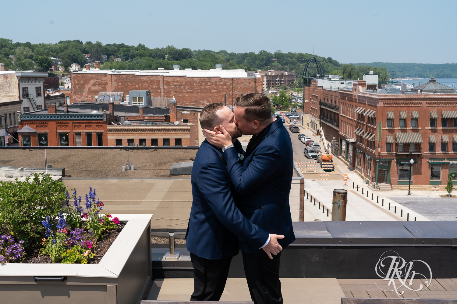 Grooms kiss during first look on rooftop before gay wedding in Stillwater, Minnesota.