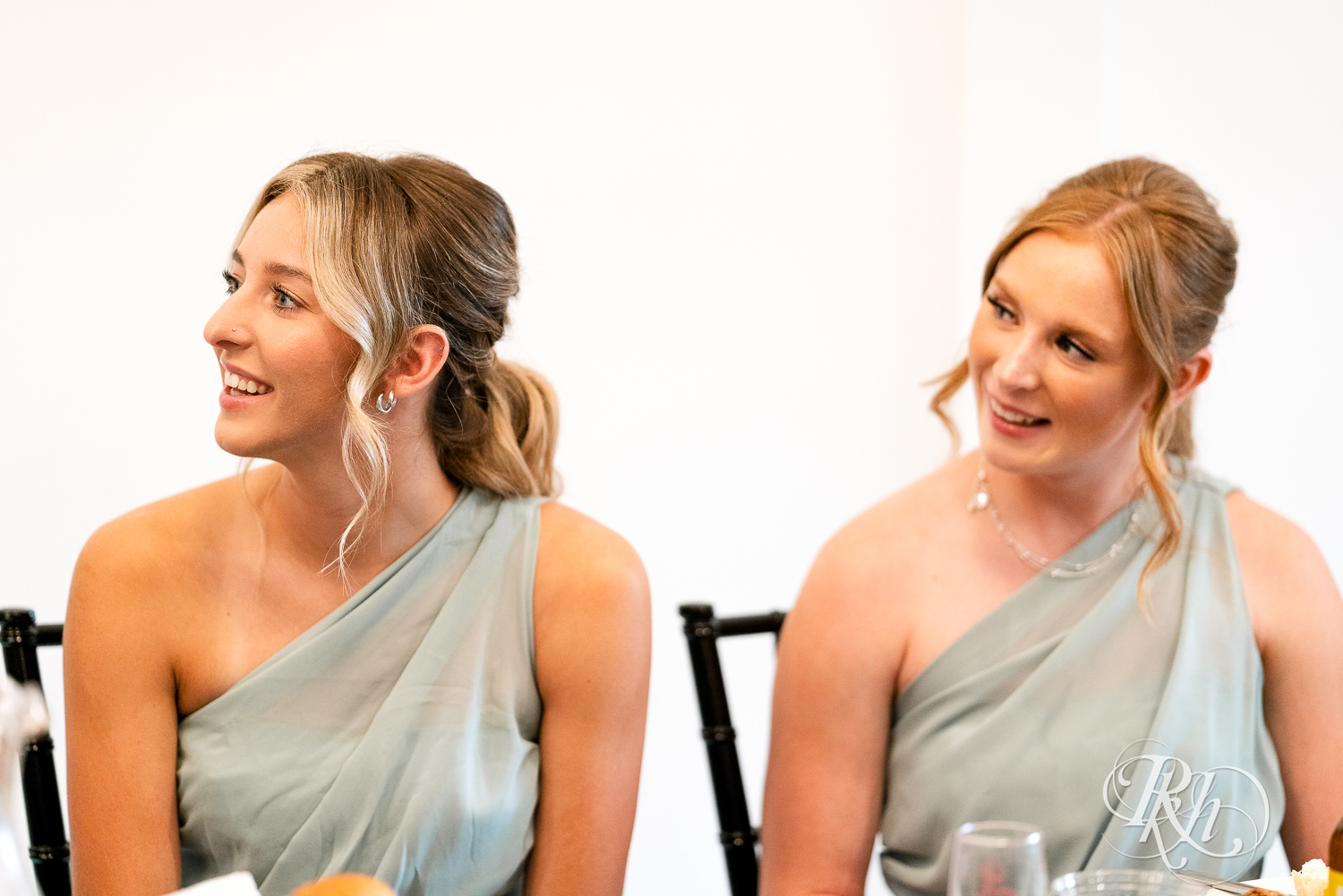 Bridesmaids smiling during wedding reception at Ahavah Cottage in Elysian, Minnesota.