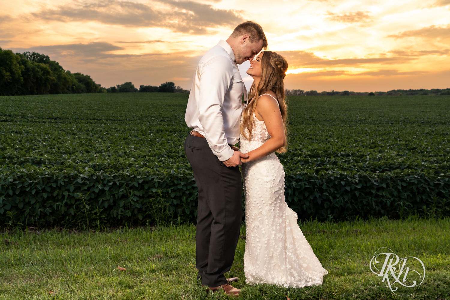 Bride and groom smile during sunset at Ahavah Cottage in Elysian, Minnesota.