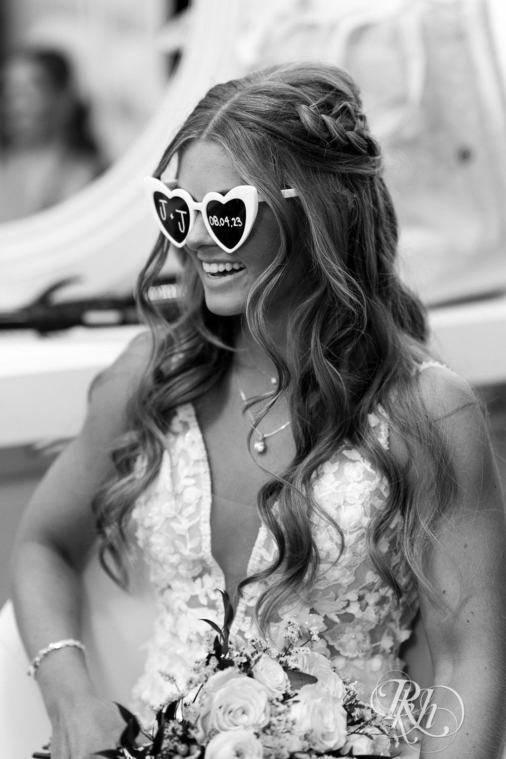 Bride laughing with sunglasses on on wedding day at Ahavah Cottage in Elysian, Minnesota.