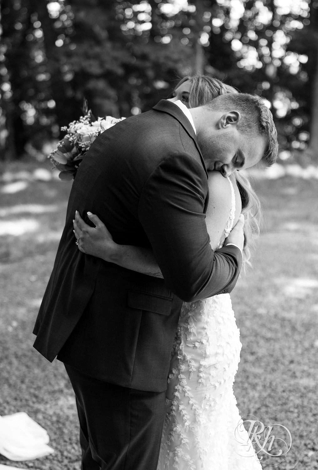 Bride and groom hug during first look on wedding day at Ahavah Cottage in Elysian, Minnesota.