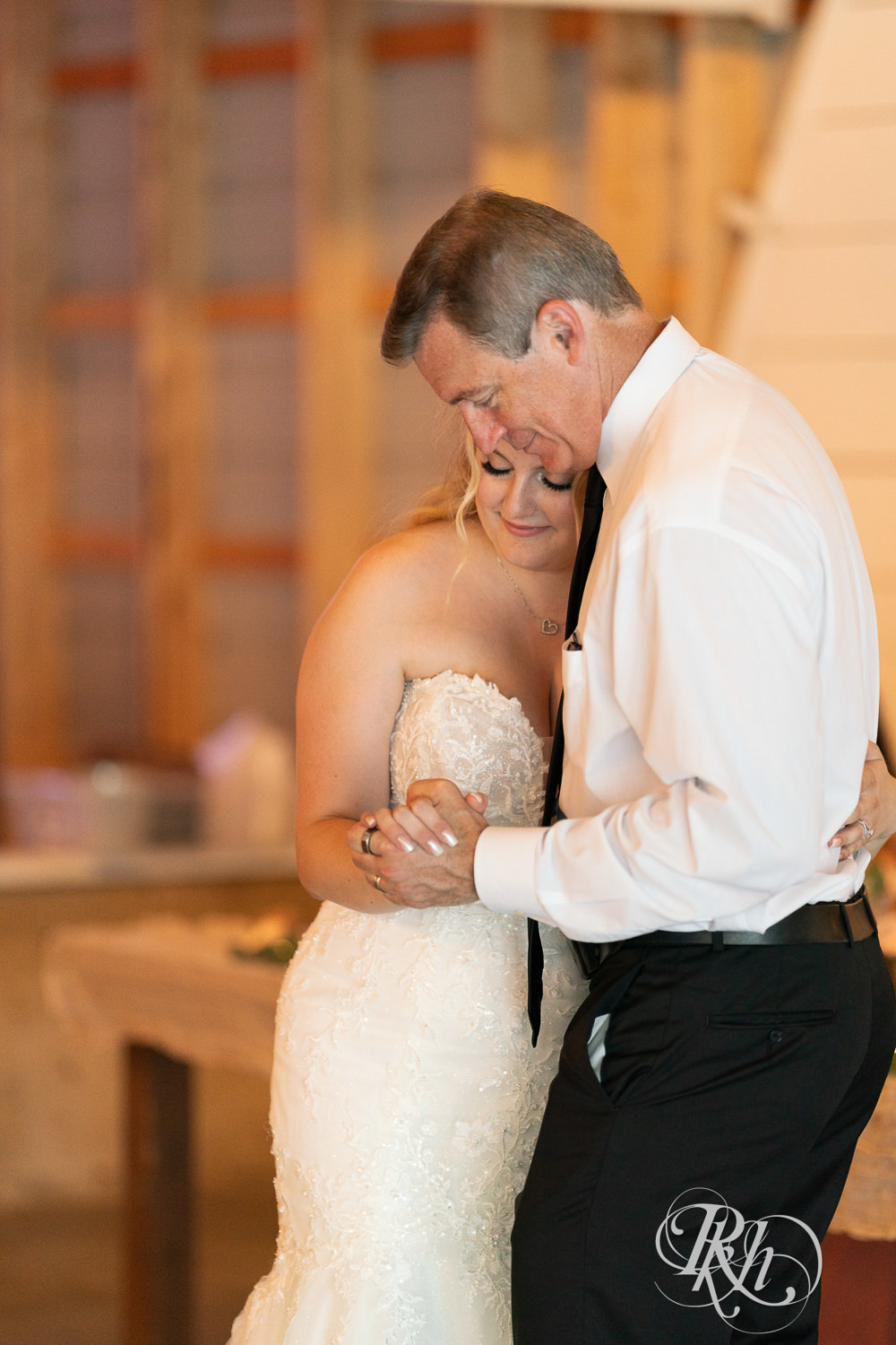 Bride dances with dad at wedding reception at Cottage Farmhouse in Glencoe, Minnesota.