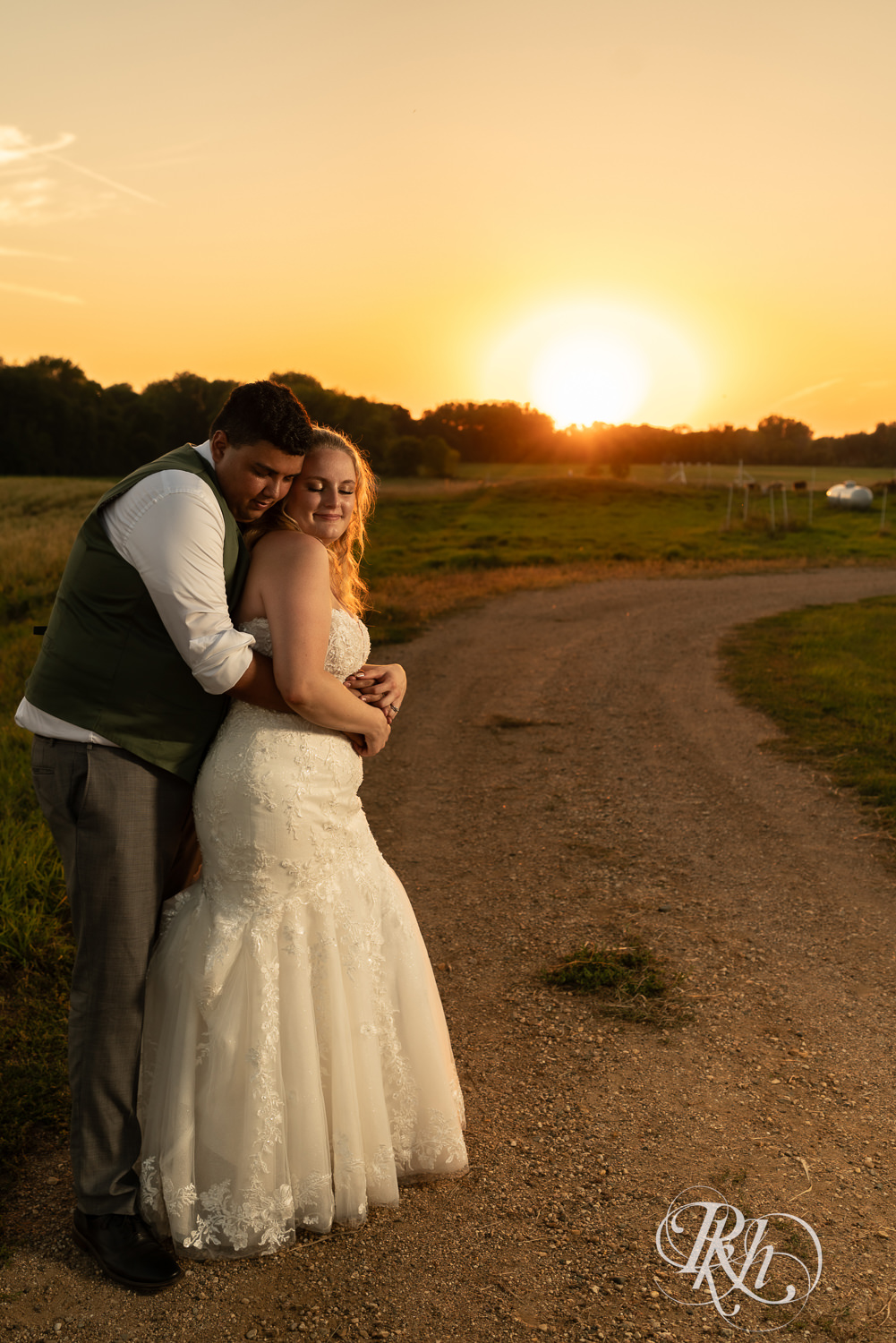 Bride and groom snuggle at sunset on wedding day at Cottage Farmhouse in Glencoe, Minnesota.