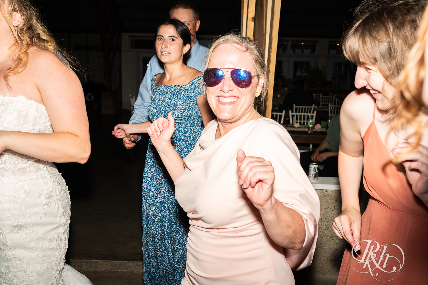 Guests dance during wedding reception at Cottage Farmhouse in Glencoe, Minnesota.