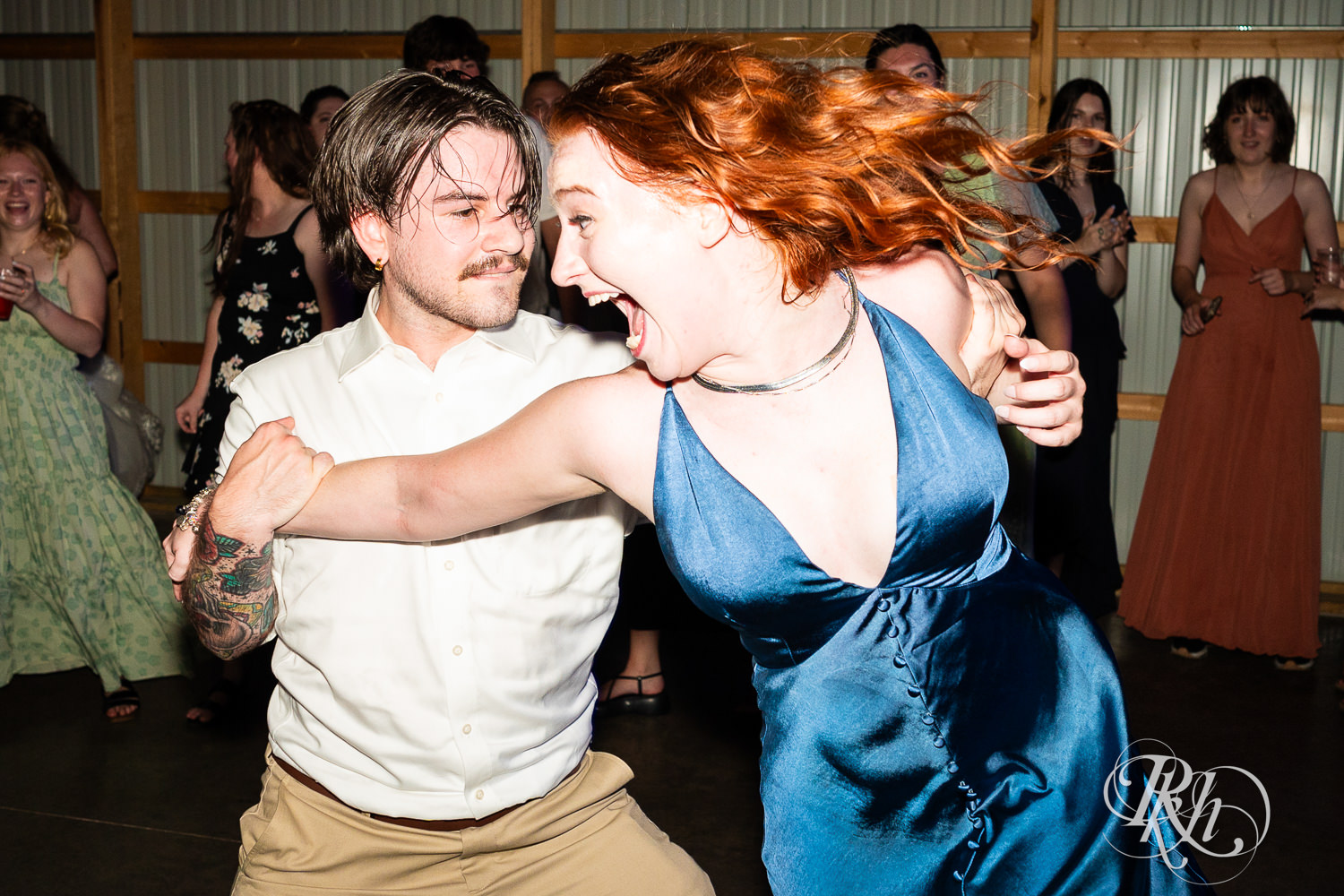 Guests dance during wedding reception at Cottage Farmhouse in Glencoe, Minnesota.
