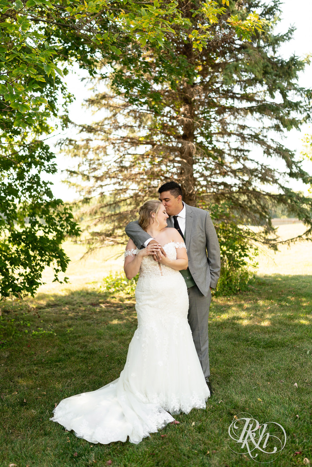Bride and groom kiss on wedding day at Cottage Farmhouse in Glencoe, Minnesota.