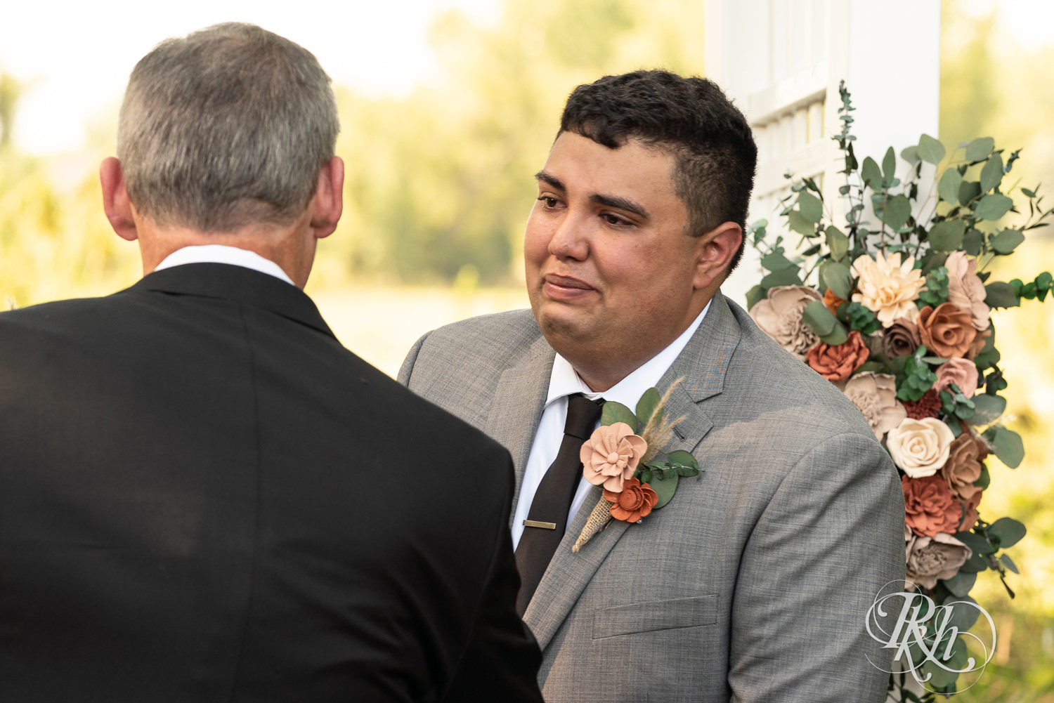 Groom cries seeing bride walking down the aisle at Cottage Farmhouse in Glencoe, Minnesota.