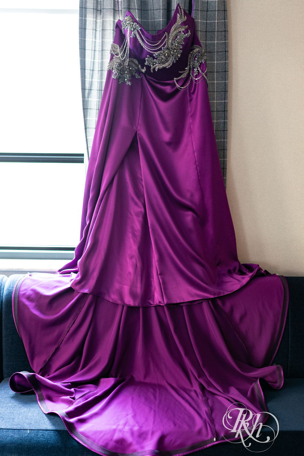 Purple wedding dress hanging on the wall. 