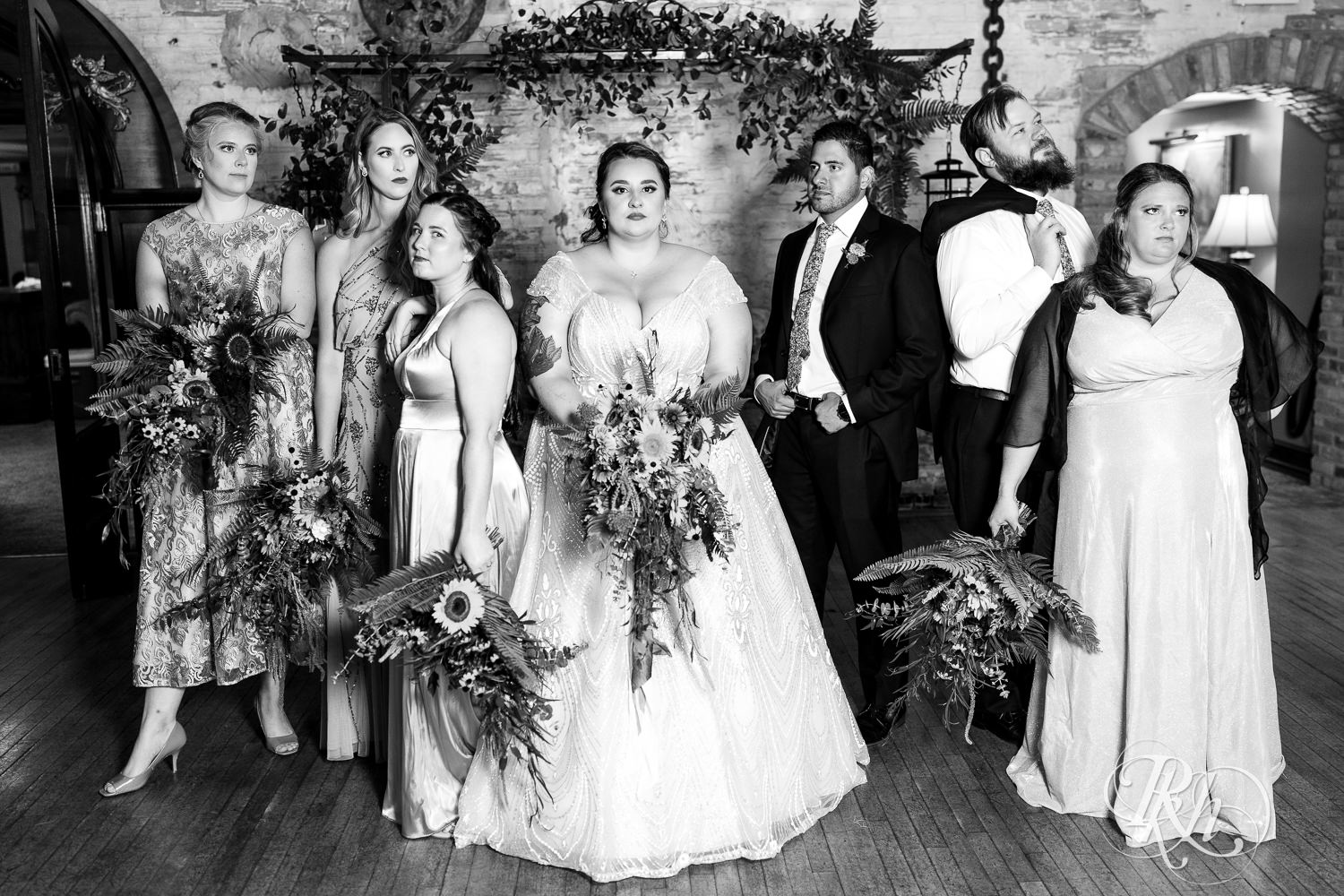 Plus size bride and groom smile with wedding party at Kellerman's Event Center in White Bear Lake, Minnesota.
