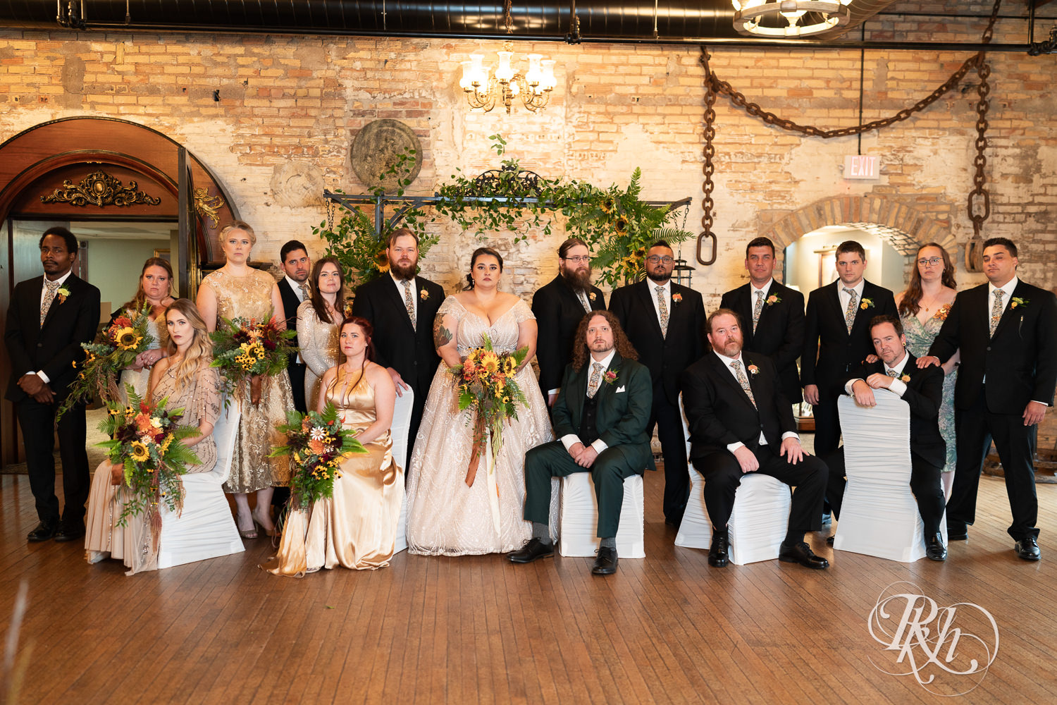 Plus size bride and groom smile with wedding party at Kellerman's Event Center in White Bear Lake, Minnesota.
