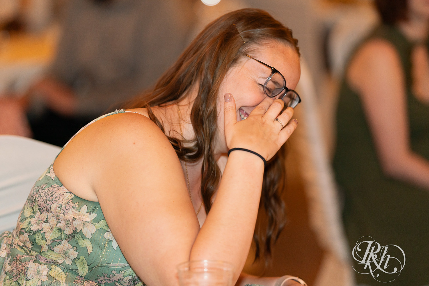 Guests laugh during speech at wedding reception at Kellerman's Event Center in White Bear Lake, Minnesota.