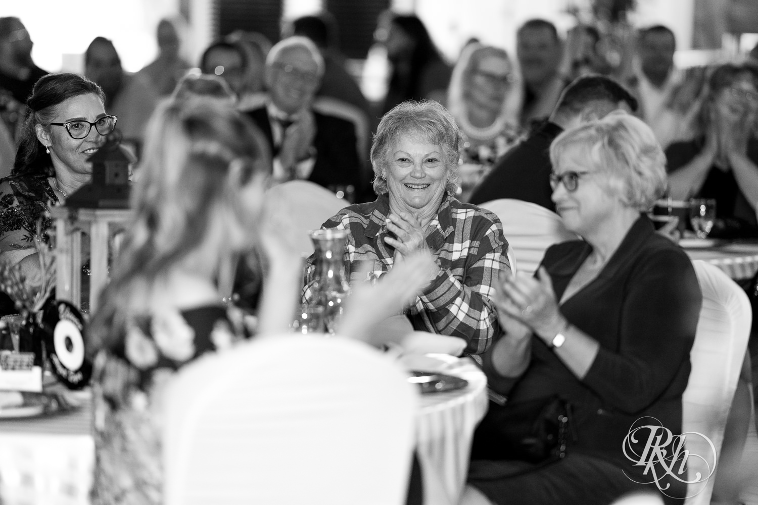 Guests laugh during speech at wedding reception at Kellerman's Event Center in White Bear Lake, Minnesota.