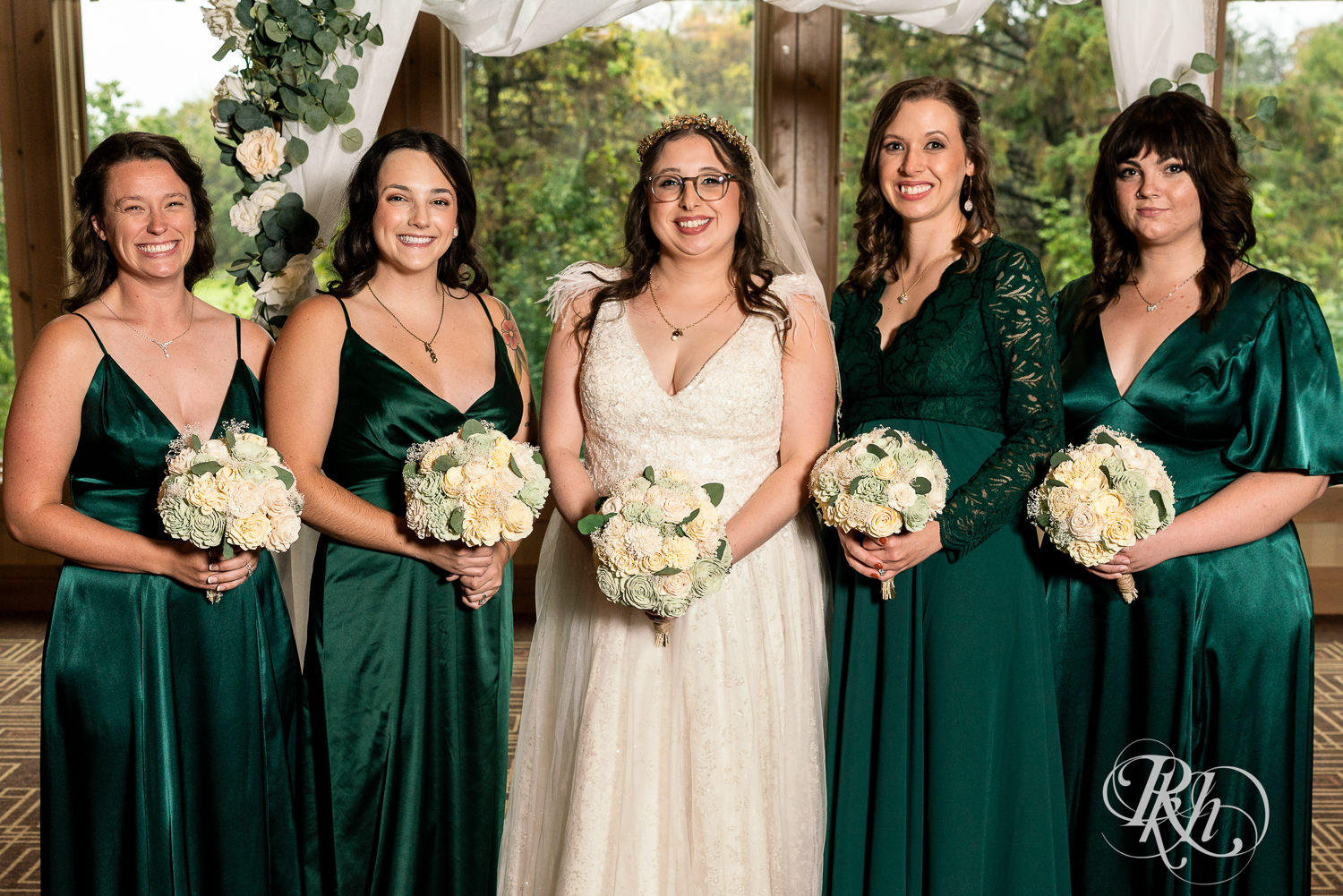 Bride smiles with wedding party at Bunker Hills Event Center in Coon Rapids, Minnesota.