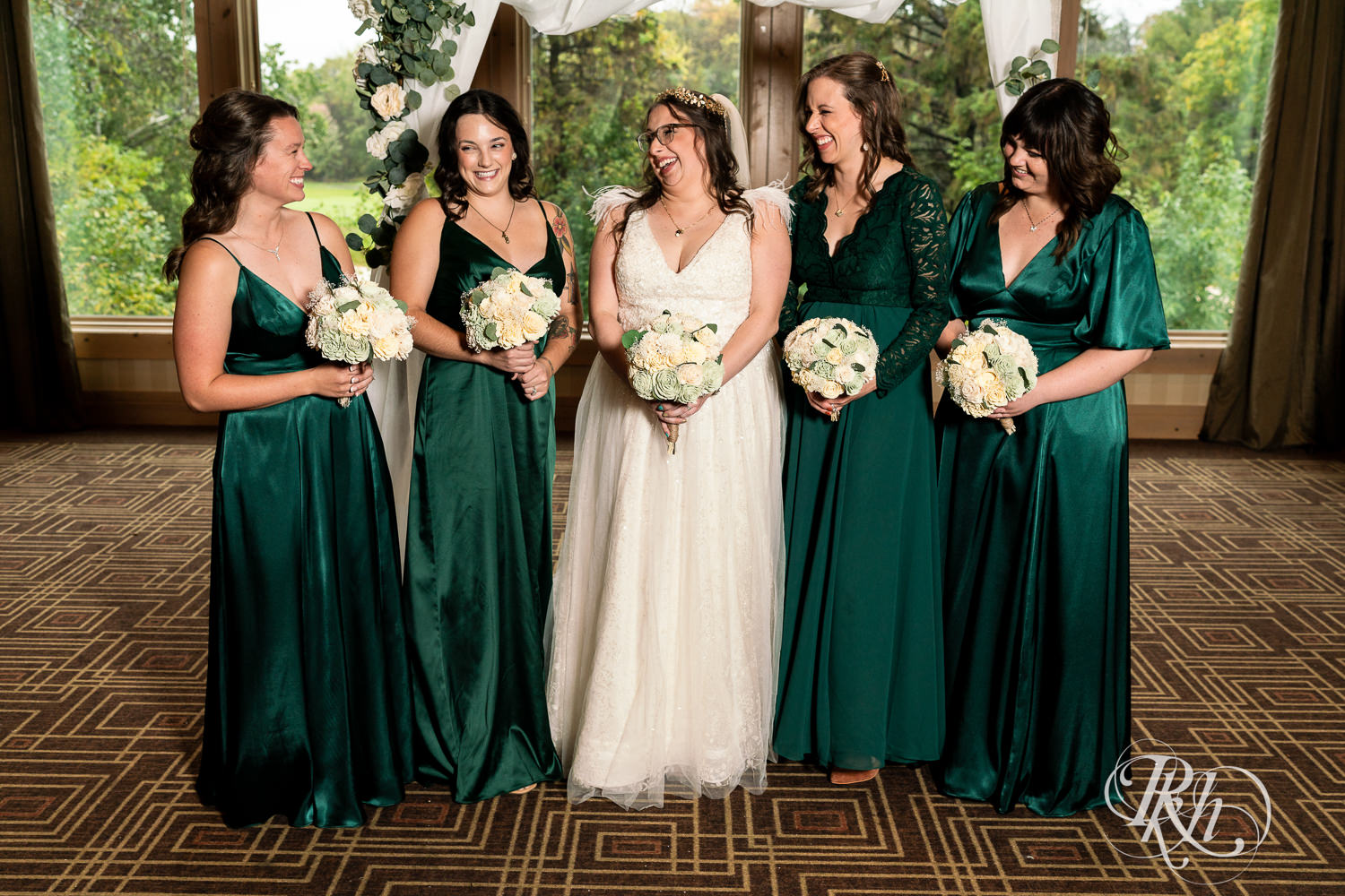 Bride smiles with wedding party at Bunker Hills Event Center in Coon Rapids, Minnesota.