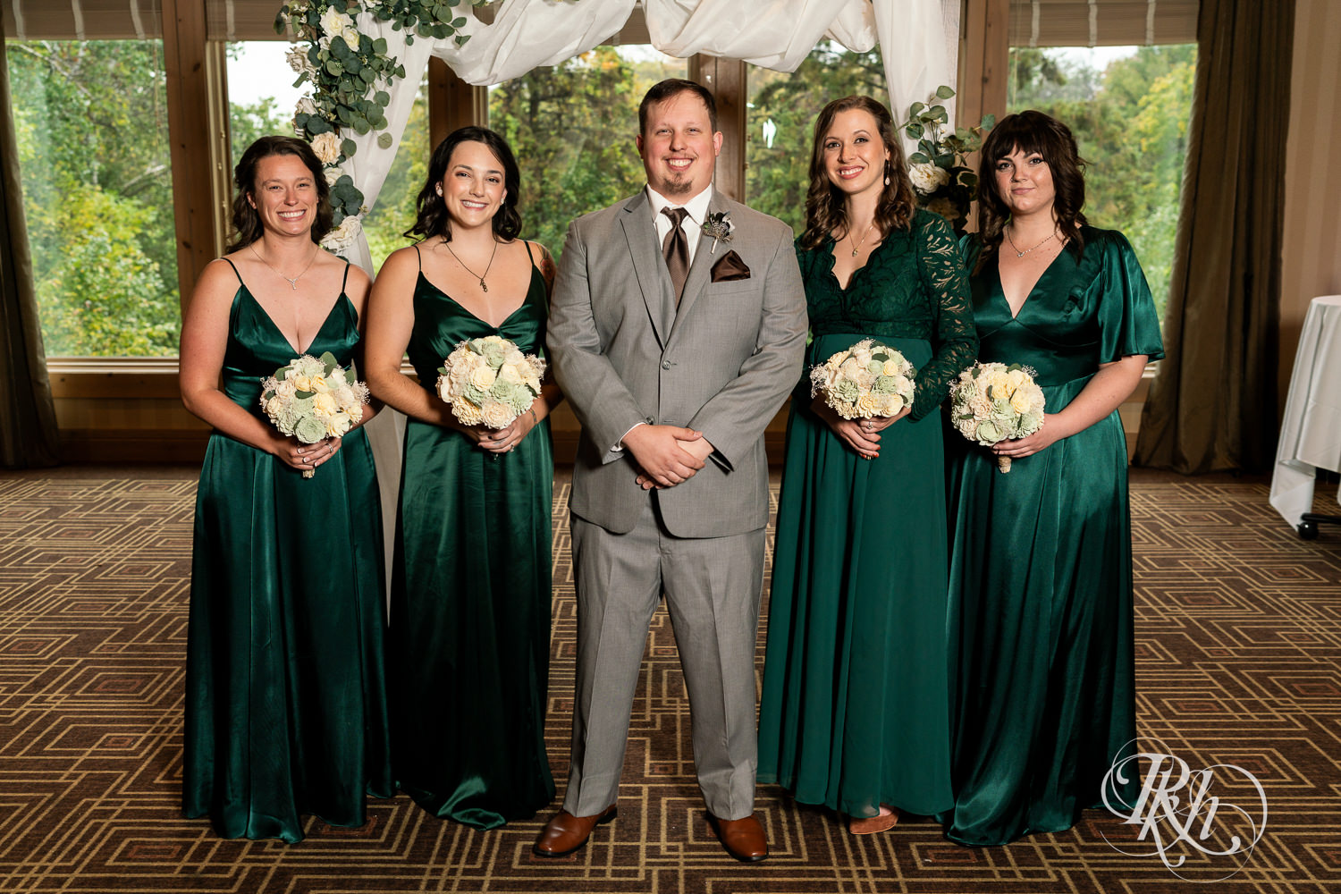 Groom smiles with wedding party at Bunker Hills Event Center in Coon Rapids, Minnesota.