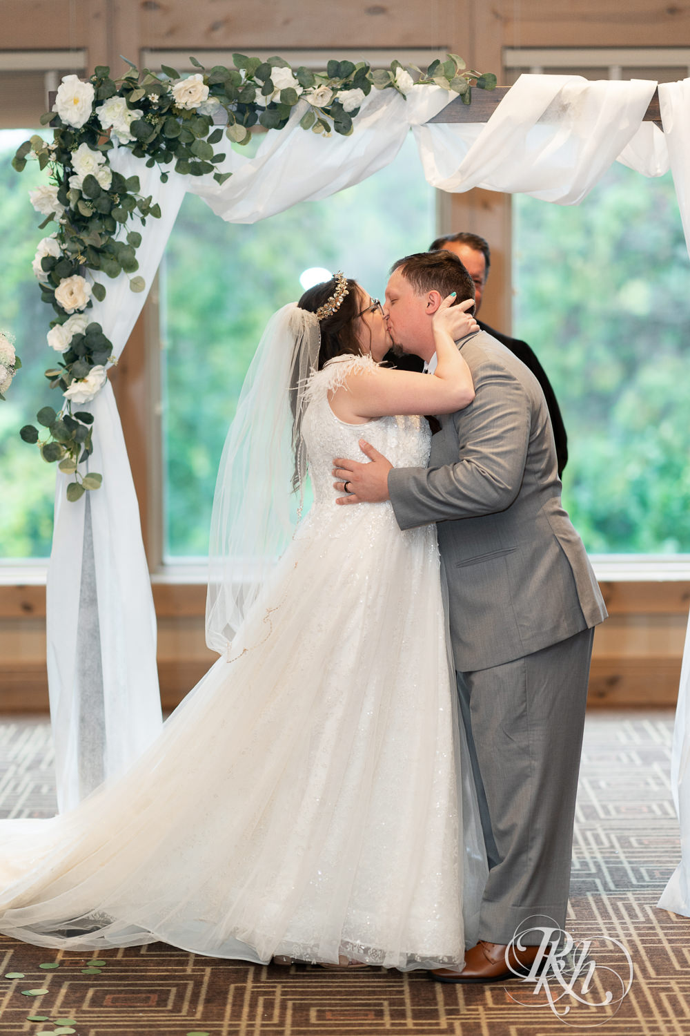 Bride and groom kiss during the wedding ceremony at Bunker Hills Event Center in Coon Rapids, Minnesota.