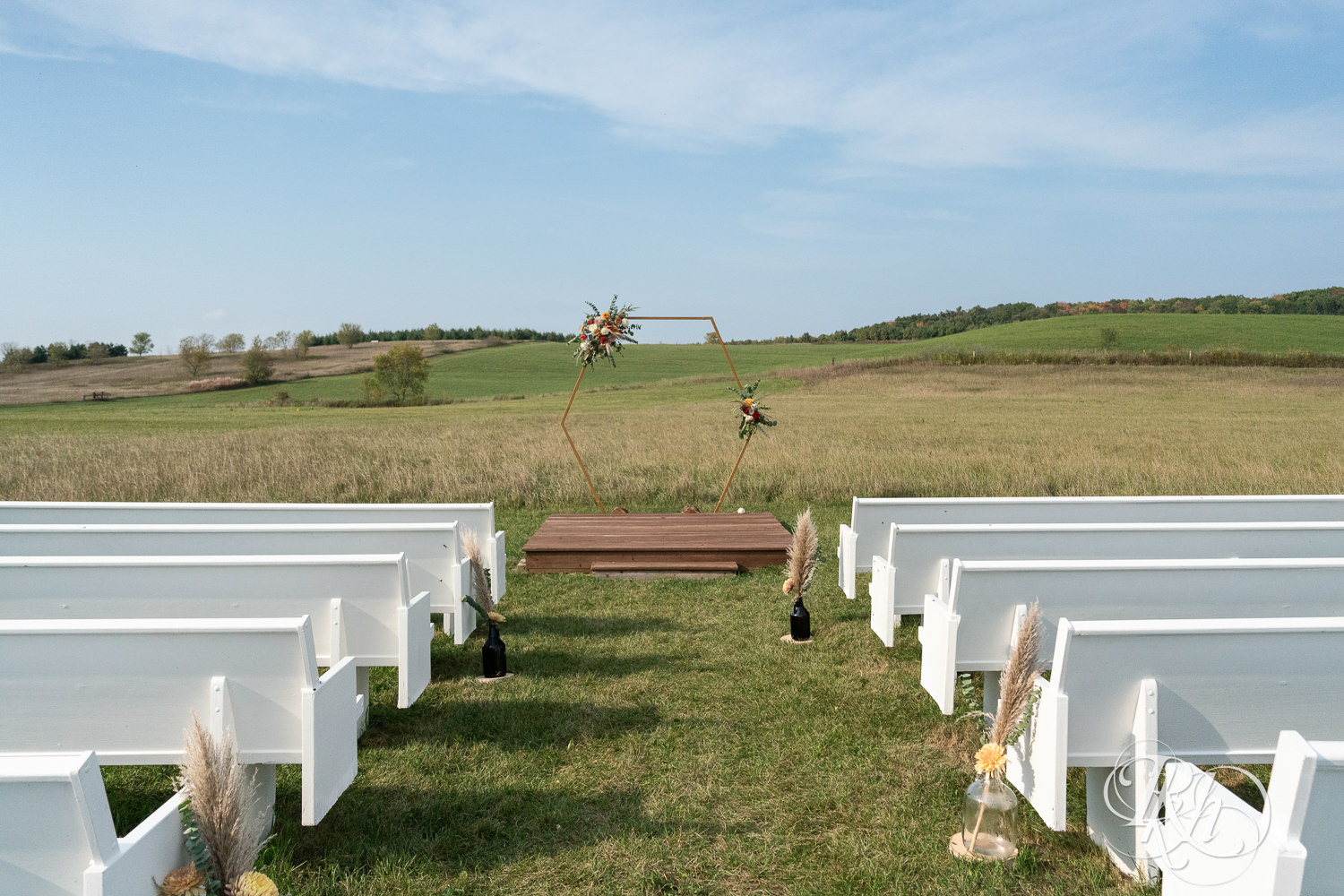 Outdoor wedding ceremony setup at Hayvn at Hay River in Boyceville, Wisconsin. 