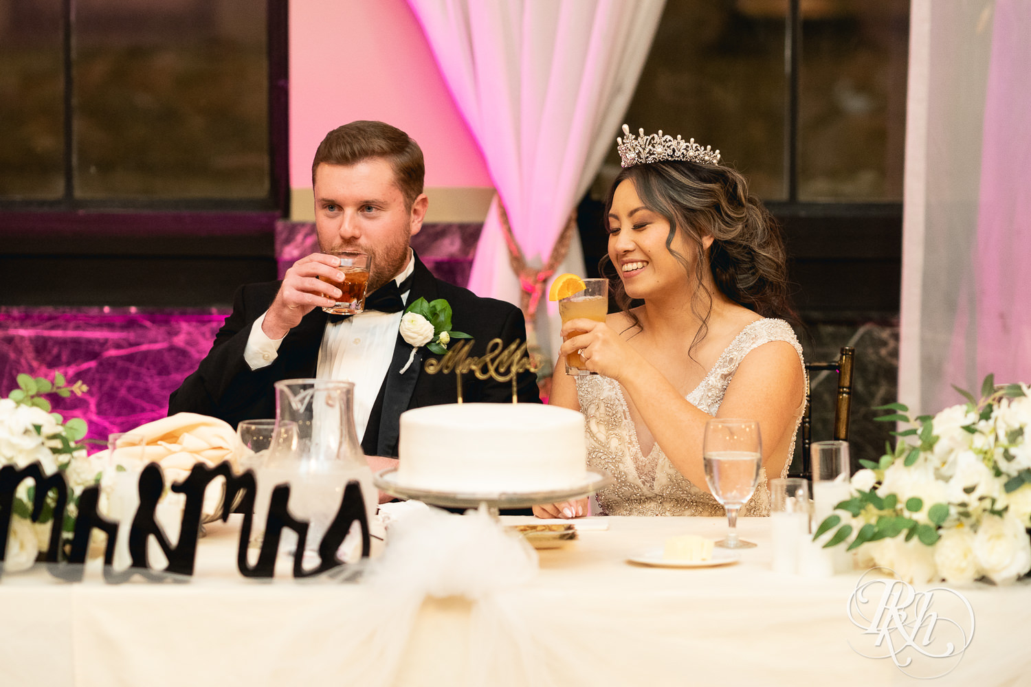 Bride, groom and guests smile during speeches at the Saint Paul Athletic Club in Saint Paul, Minnesota.