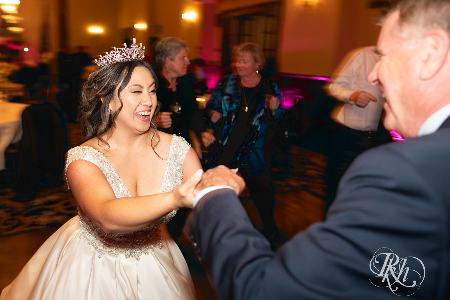 Hmong bride and groom dance with guests at the Saint Paul Athletic Club in Saint Paul, Minnesota.